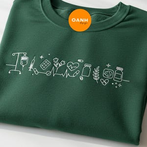 Embroidered Nurse Icon Crewneck Sweatshirt, Minimalist RN Nursing Gift for Women, Cute Custom Doodle Medical Top for Healthcare Workers