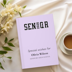 May include: A white ceramic mug with a black handle and the text "But First, Coffee" in a black, bold font. The mug is on a white surface.