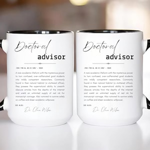 May include: Two white ceramic mugs with black handles and rims. Each mug features the text "Doctoral advisor" in a stylish font, along with a definition. The mugs are designed for academics and researchers.