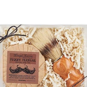 A shave soap and boar bristle brush gift set box, with a Fuzzy Fleegal shave bar scented with cedar, lavender and rosemary.