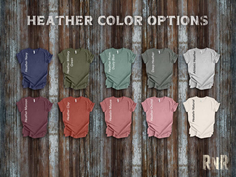 May include: Ten different colors of heather t-shirts with ruffled edges. The colors are: Heather Navy, Heather Military Green, Heather Prism Dusty Blue, Deep Heather, Athletic Heather, Heather Maroon, Heather Clay, Heather Mauve, Heather Orchid, and Heather Natural.