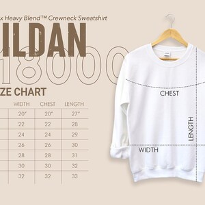 May include: A white Gildan 18000 crewneck sweatshirt on a wooden hanger. The image includes a size chart with measurements in inches, converted to cm, for width, chest, and length. The size chart ranges from S to 4XL.