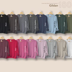 May include: A selection of Gildan 18000 crewneck sweatshirts in a range of colours, such as black, dark chocolate, charcoal, dark heather, navy, light blue, forest, and military green. Other colours include maroon, red, and white.