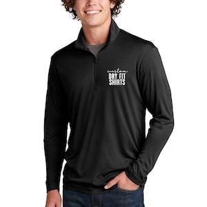 May include: Black long-sleeved quarter-zip shirt with the text "custom DRY FIT SHIRTS" in white. The shirt features a stand-up collar and a zip that extends down the chest.