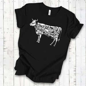 May include: Black t-shirt with a white graphic of a cow divided into different cuts of meat, labeled with names like "Chuck", "Brisket", and "Rib".