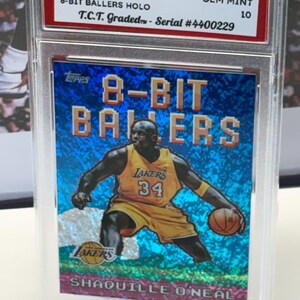 May include: A 2025 Topps NBA trading card featuring Shaquille O'Neal in a Los Angeles Lakers uniform. The card is part of the 8-Bit Ballers Holo series and is graded GEM MINT 10. The card is encased in a protective holder.