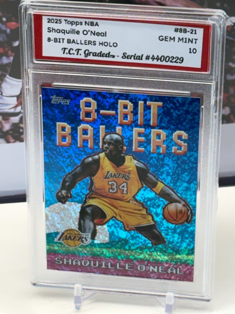 May include: A 2025 Topps NBA trading card featuring Shaquille O'Neal in a Los Angeles Lakers uniform. The card is part of the 8-Bit Ballers Holo series and is graded GEM MINT 10. The card is encased in a protective holder.