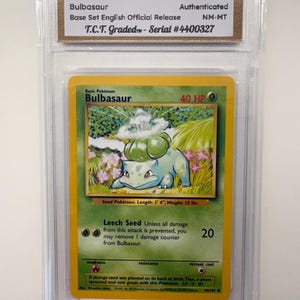 May include: A graded Pokémon Bulbasaur card from 1999, Base Set English Official Release. The card is encased in a protective holder and features the text "Bulbasaur" and "Leech Seed". The card is graded NM-MT and has a serial number.