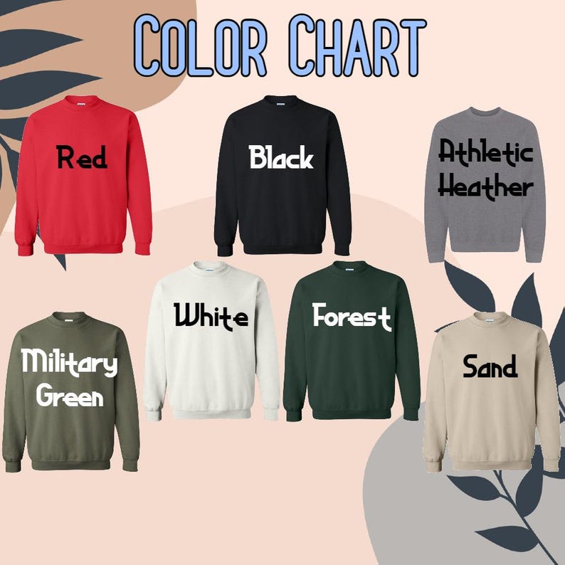 Puede incluir: Una carta de colores muestra siete sudaderas de cuello redondo en varios colores: rojo, negro, gris atl&eacute;tico, verde militar, blanco, verde bosque y arena. El texto "COLOR CHART" est&aacute; en la parte superior en azul, con cada color de sudadera etiquetado debajo.