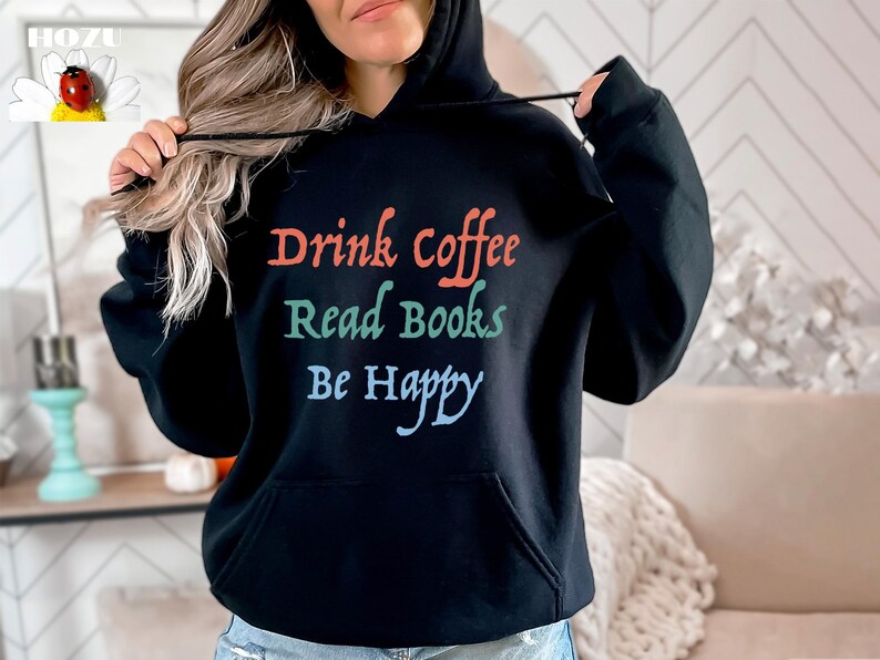 May include: Black hooded sweatshirt with the text "Drink Coffee Read Books Be Happy" in colourful lettering.