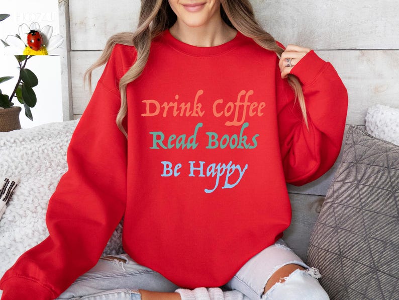May include: Red sweatshirt with the text "Drink Coffee Read Books Be Happy" in colourful lettering.