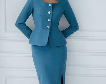 May include: A teal blue skirt suit with a fitted jacket and a skirt with a slit. The jacket has a round neckline and pearl buttons.