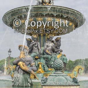 May include: A large, ornate fountain with multiple tiers and sculptures. The fountain features detailed bronze figures, water cascading down, and a decorative design. The image includes the text "Copyright MobilePix.ETSY.COM".