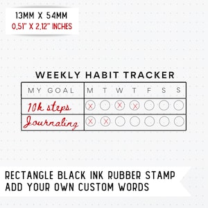 May include: Black ink rubber stamp with the text "Weekly Habit Tracker" and a grid for tracking habits. The grid includes the days of the week and space for two habit goals. The goals are "10k steps" and "Journaling".