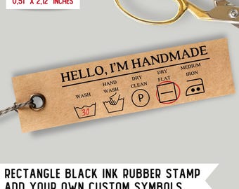 May include: A brown rectangular rubber stamp with the text "HELLO, I'M HANDMADE" and various laundry care symbols. The symbols include hand wash, dry clean, dry flat, and medium iron. The stamp measures 0.51 inches by 2.12 inches.