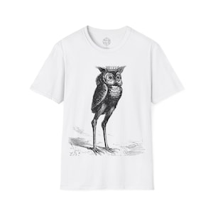 May include: White t-shirt with a black and white illustration of an owl wearing a crown. The owl is standing on a branch with leaves.