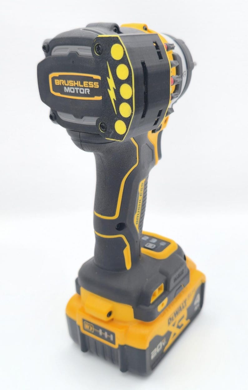 May include: Black and yellow cordless drill with the text "BRUSHLESS MOTOR". The drill has a black handle and a yellow battery pack. The drill is designed for various construction and DIY projects.