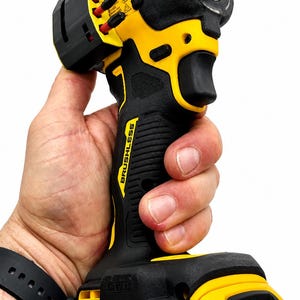 May include: A black and yellow cordless drill with the brand name "DEWALT" visible. The drill is labeled "BRUSHLESS" and "XR". The battery is labeled "20V MAX" and "4 AH".