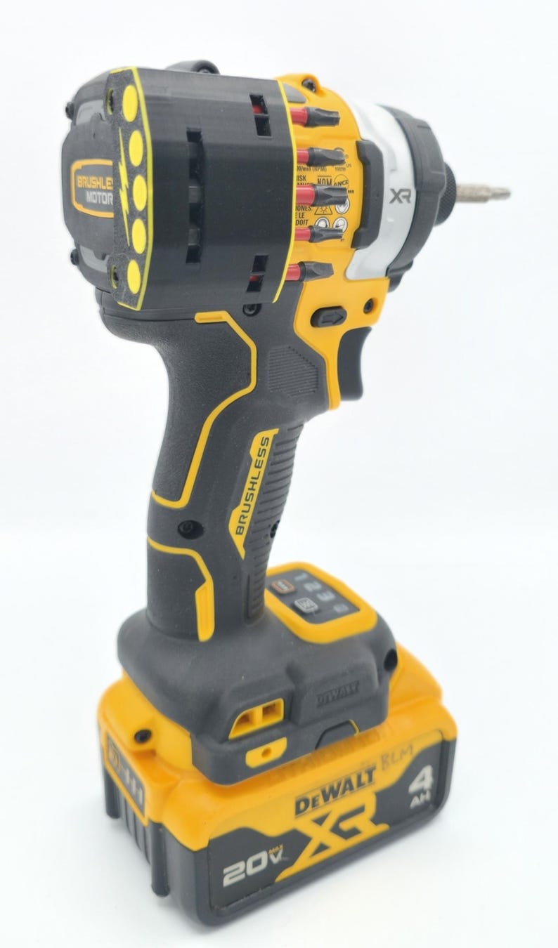 May include: A black and yellow cordless impact driver with a battery pack. The tool has the text "BRUSHLESS MOTOR" and "BRUSHLESS" printed on it. The battery pack has the text "DEWALT XR 20V" and "4 AH" printed on it.