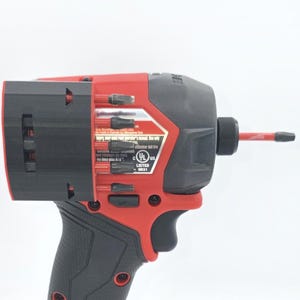 May include: A red and black cordless impact driver with a black handle. The tool has a black head with a red accent and a red bit extending from the front. The tool has a UL Listed sticker.