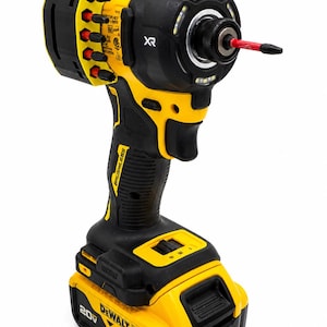 May include: A black and yellow cordless impact driver with a red bit. The tool has the text "BRUSHLESS" and "20V XR" printed on it. The battery is labeled "4 AH".