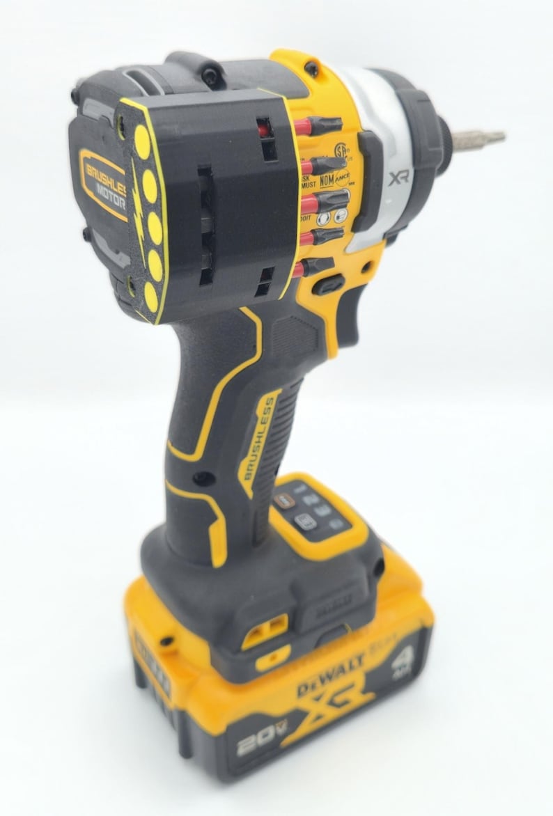 May include: A black and yellow cordless impact driver with a silver head. The tool has the text "BRUSHLESS MOTOR" and "BRUSHLESS" printed on it. The battery reads "20V".
