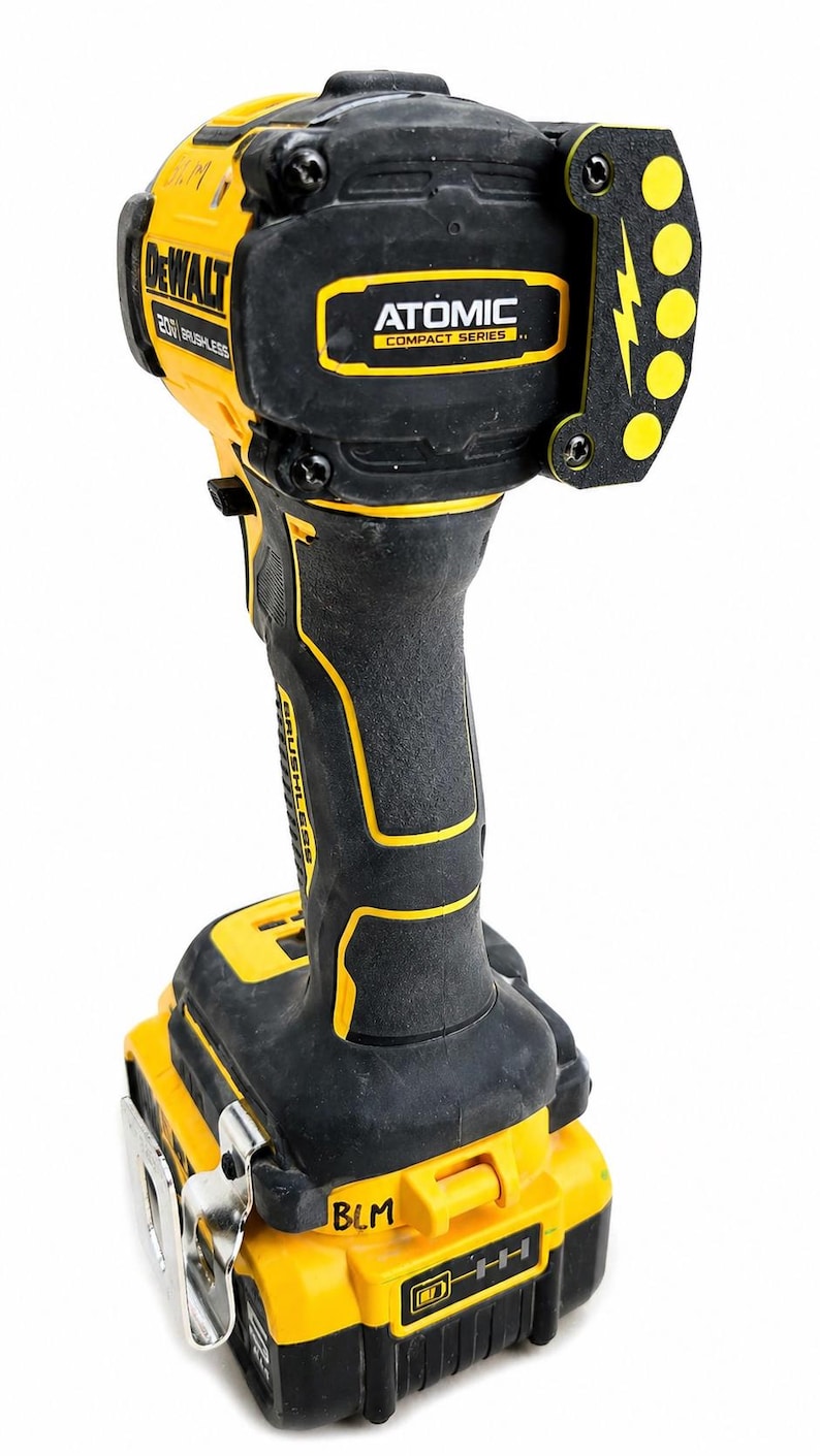May include: A black and yellow DeWalt Atomic Compact Series 20V brushless impact driver. The tool has a black handle with yellow accents, a yellow battery base, and a black head with the Atomic logo and a lightning bolt design.