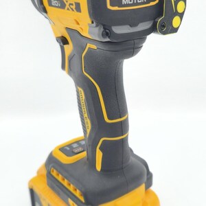 May include: A yellow and black DeWalt 20V XR brushless impact driver with a battery pack. The tool has the words "DeWalt" and "Brushless Motor" printed on it. The battery pack is labeled "4 AH".