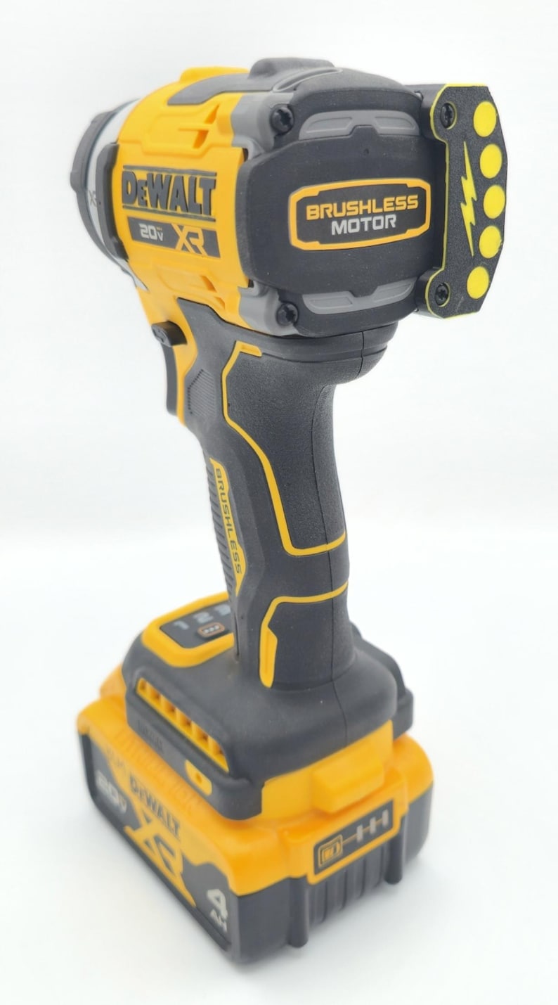 May include: A yellow and black DeWalt 20V XR brushless impact driver with a battery pack. The tool has the words "DeWalt" and "Brushless Motor" printed on it. The battery pack is labeled "4 AH".