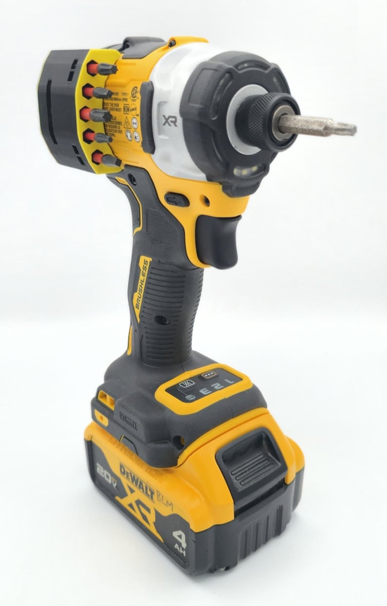May include: A yellow and black cordless impact driver with a silver bit. The tool has the brand name "DEWALT" and "XR" printed on it. The battery is labeled "20V" and "4 AH".