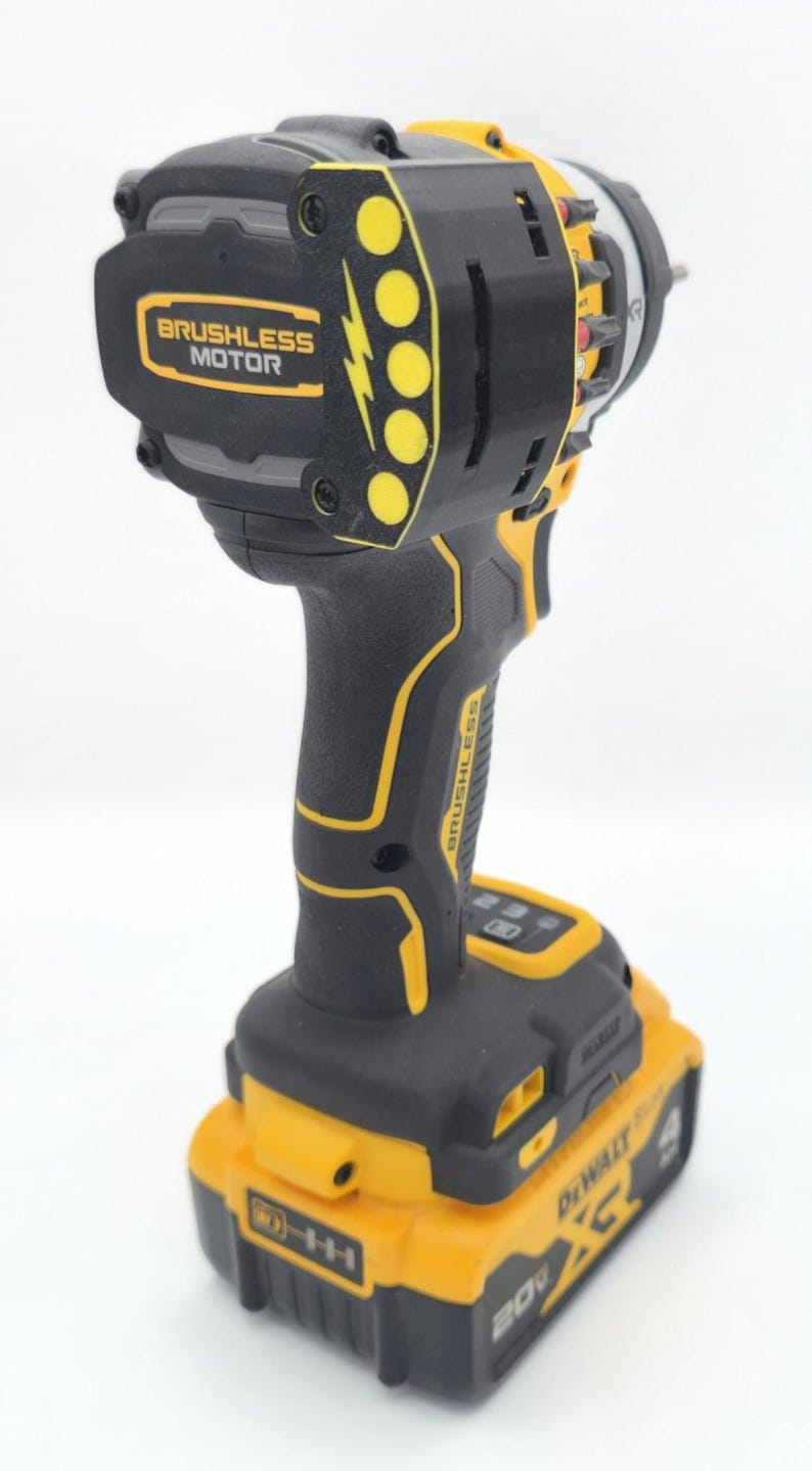 May include: Black and yellow cordless drill with a brushless motor. The drill has a black handle and body with yellow accents and a yellow battery pack. The text "BRUSHLESS MOTOR" is visible on the drill.
