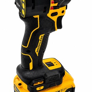 May include: A black and yellow cordless impact wrench with a 20V battery. The tool has the brand name "DEWALT" and "BRUSHLESS" printed on it. The battery is labeled "4 AH".