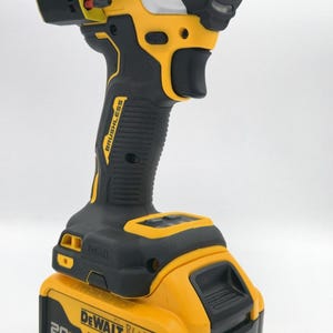 May include: A yellow and black DeWalt XR brushless impact driver with a 20V battery. The tool has a black handle and a silver and yellow head. The battery is labeled 4 AH.