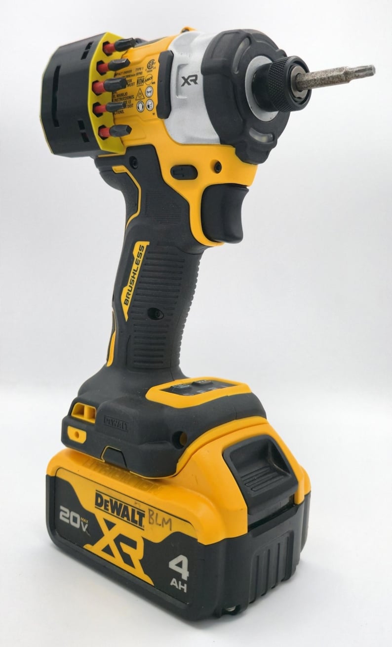 May include: A yellow and black DeWalt XR brushless impact driver with a 20V battery. The tool has a black handle and a silver and yellow head. The battery is labeled 4 AH.