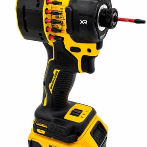 May include: A black and yellow cordless impact driver with a red bit extending from the front. The tool has a black handle and a yellow battery pack. The brand name "DEWALT" is visible on the battery.