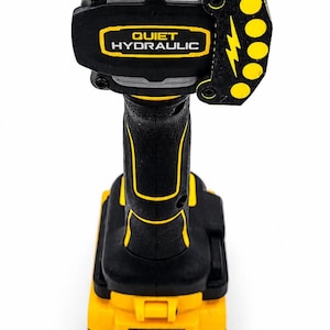 May include: A black and yellow cordless impact wrench with the text "QUIET HYDRAULIC". The tool has a battery pack and a lightning bolt symbol. The tool is designed for heavy-duty use.