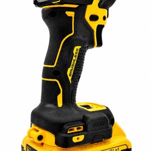 May include: Black and yellow cordless drill with the text "QUIET HYDRAULIC" and "BRUSHLESS". The drill has a 20V MAX battery and a 4 AH rating. The brand name "DEWALT" is visible.