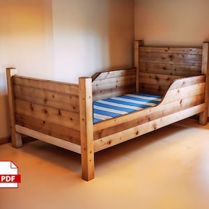 May include: A rustic wooden bed frame with a headboard and footboard. The bed is constructed from light-colored wood planks. The mattress has a blue and white striped pattern. The bed is designed for a child's room.