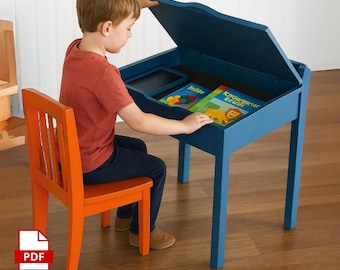 May include: A blue wooden children's desk with a hinged top, open to reveal a storage area with books and a small chalkboard. An orange chair sits in front of the desk. The desk and chair are on a wood floor.
