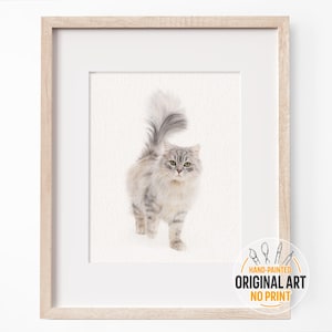 May include: A hand-painted watercolor illustration of a gray and white cat with a fluffy tail. The cat is looking directly at the viewer. The artwork is framed in a light wood frame and has a label that says "Hand-painted Original Art No Print".