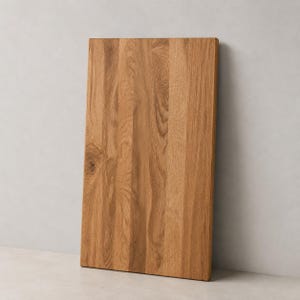 May include: A rectangular wooden cutting board made from light brown oak with a visible natural grain pattern. The board features vertical wood planks joined together, showcasing a smooth surface with a distinct knot on the left side.