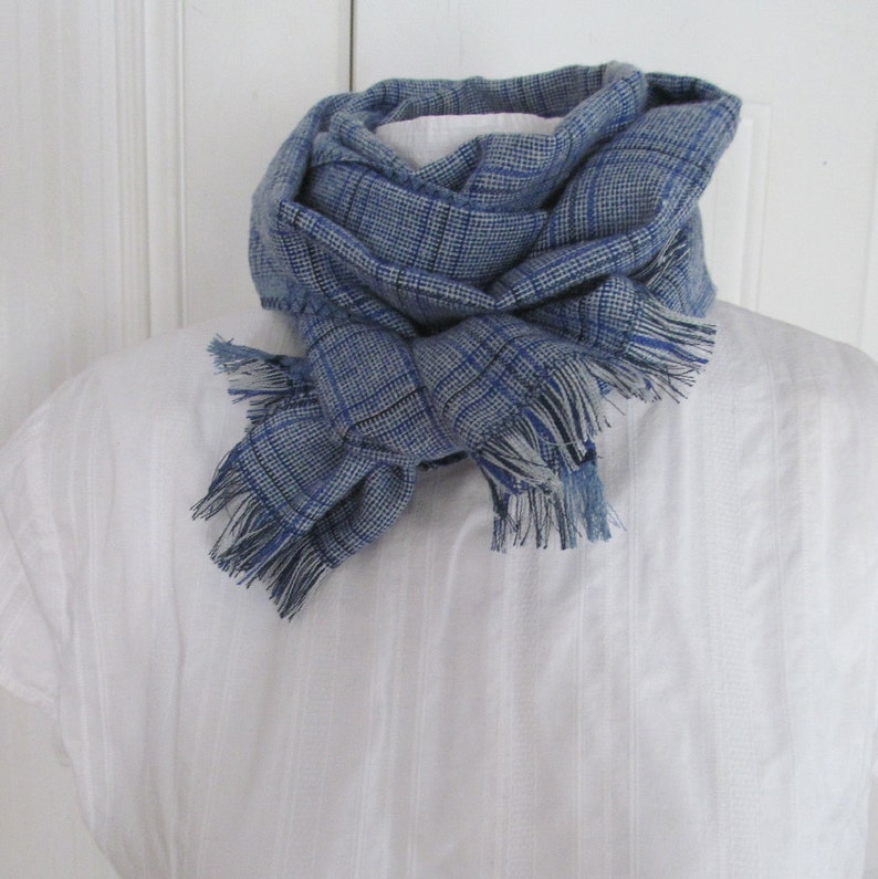 Blue and white plaid linen blend scarf is so soft. It can be wrapped around your neck 2 or 3 times and then tied to keep your neck warm.