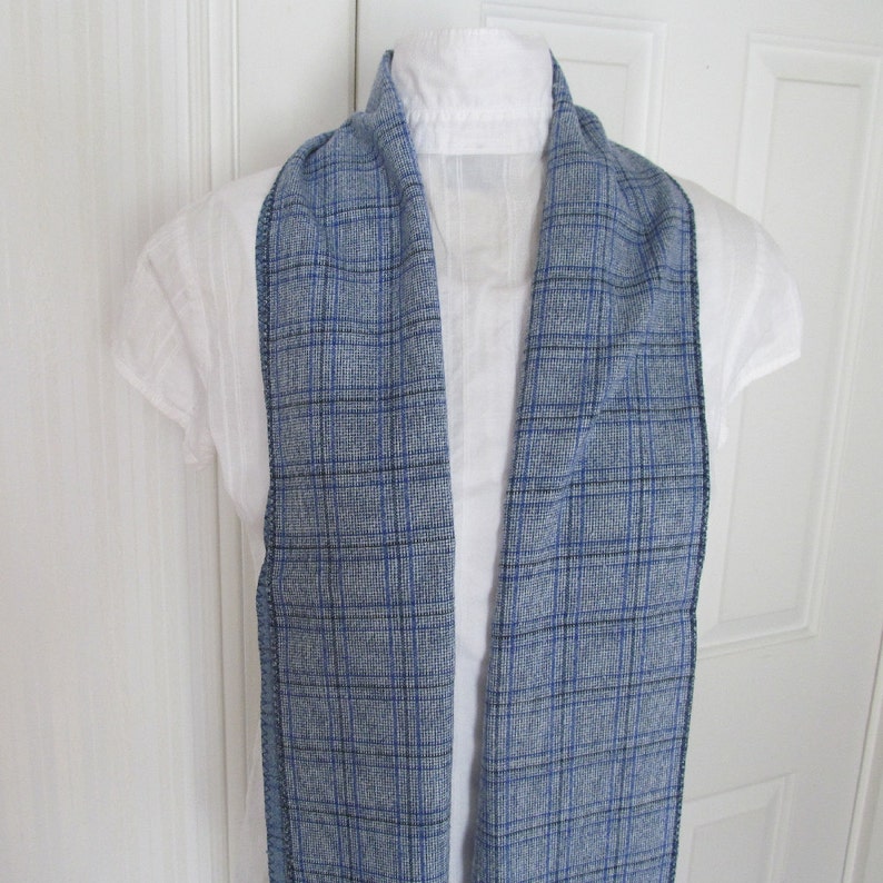 Blue and white plaid linen blend scarf measures 74 inches long and 9 1/4 inches wide. Great for tucking into the neckline of your coat or jacket.