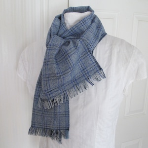 Blue and white plaid linen blend scarf is very soft and versatile. This scarf measures 74 inches long by 9 1/4 inches wide. Wear this plaid scarf wrapped twice around your neck and loosely tied to cover your neck and keep cozy warm.