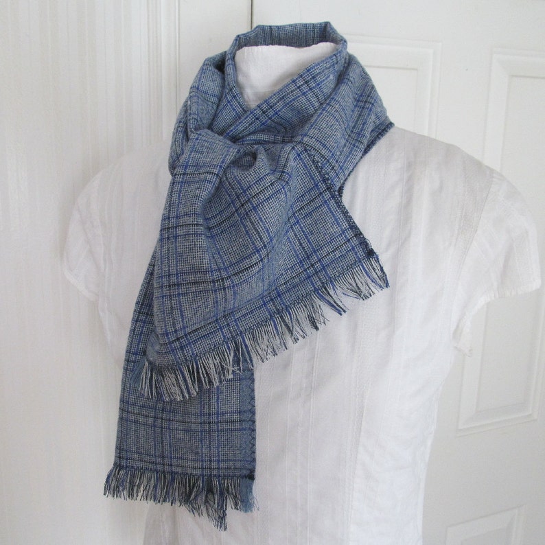 Blue and white plaid linen blend scarf is very soft and versatile. This scarf measures 74 inches long by 9 1/4 inches wide. Wear this plaid scarf wrapped twice around your neck and loosely tied to cover your neck and keep cozy warm.