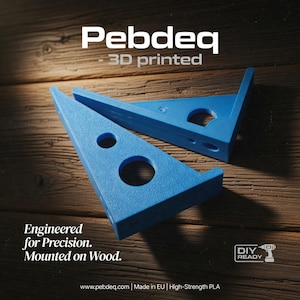 May include: Two blue, 3D-printed right angle brackets with circular cutouts. The brackets are labeled "Pebdeq" and "3D printed." The text "Engineered for Precision. Mounted on Wood." is also visible. The background is a wood surface.