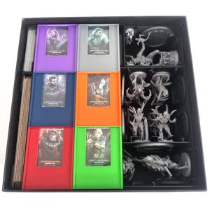 Può includere: Una scatola nera per riporre componenti di gioco. Contiene porta carte di vari colori, tra cui viola, grigio, blu, arancione, rosso e verde, ognuno con una carta personaggio. Sono incluse anche diverse miniature.
