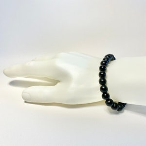 Pulsera elástica sencilla de madera negra para hombre