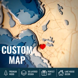 May include: A custom 3D layered wooden map with blue water detail and a red heart marker. The words "CUSTOM MAP" are prominently displayed. The map is labeled "PREMIUM WOOD", "3D LAYERED DESIGN", "PERFECT GIFT", and "LAKE HOUSE DECOR".