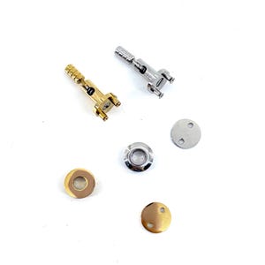 May include: A selection of metal hardware components, including two small latches, two circular pieces, and two small, round, flat pieces. One latch is gold-toned, the other is silver-toned. The circular pieces are silver and gold-toned. The flat pieces are silver and gold-toned.